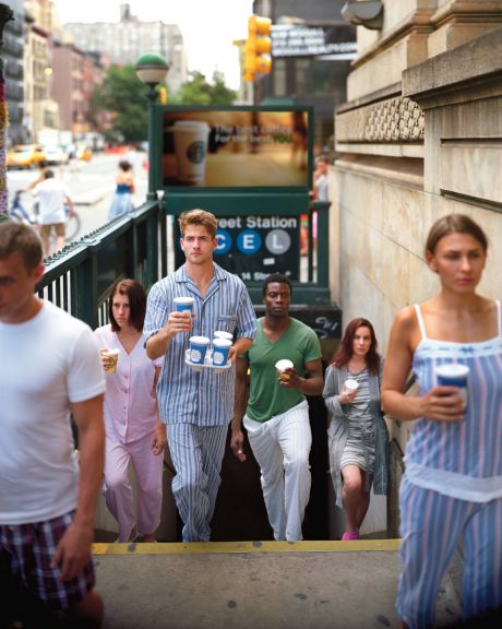  People emerging from subway in PJs w/ coffee
